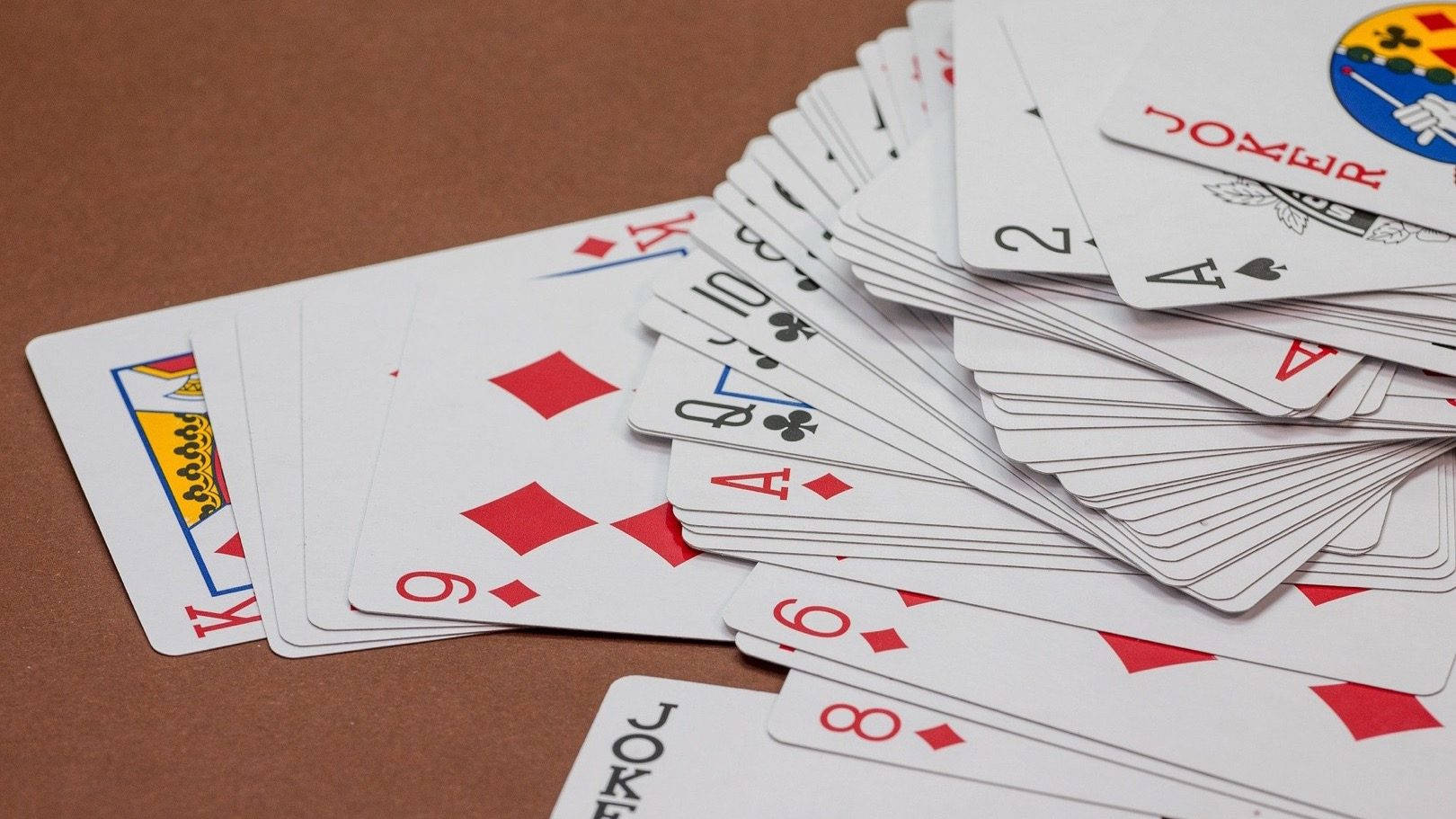 Scattered Deck Of Rummy Playing Cards Wallpaper