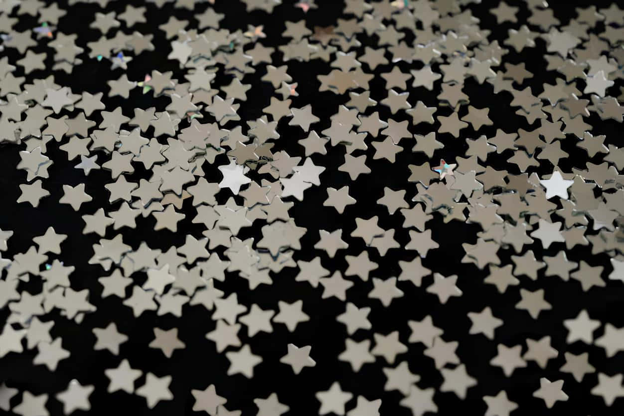 Scattered Silver Starson Black Background Wallpaper