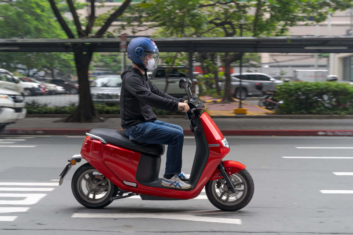 Scooter Red Driving On Road Picture