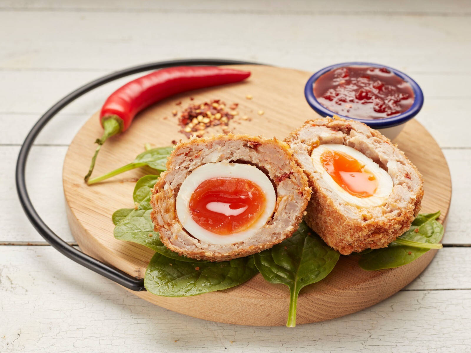 Scotch Egg Dish With Spinach And Chili Sauce Wallpaper