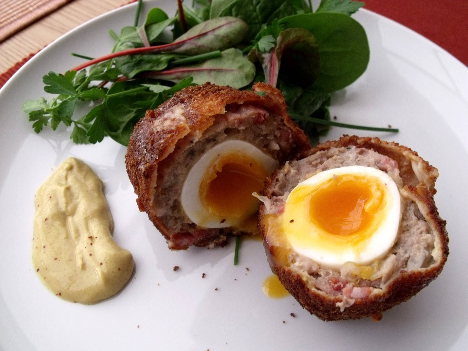 Scotch Eggs Dish With Spinach And Creamy Sauce Wallpaper