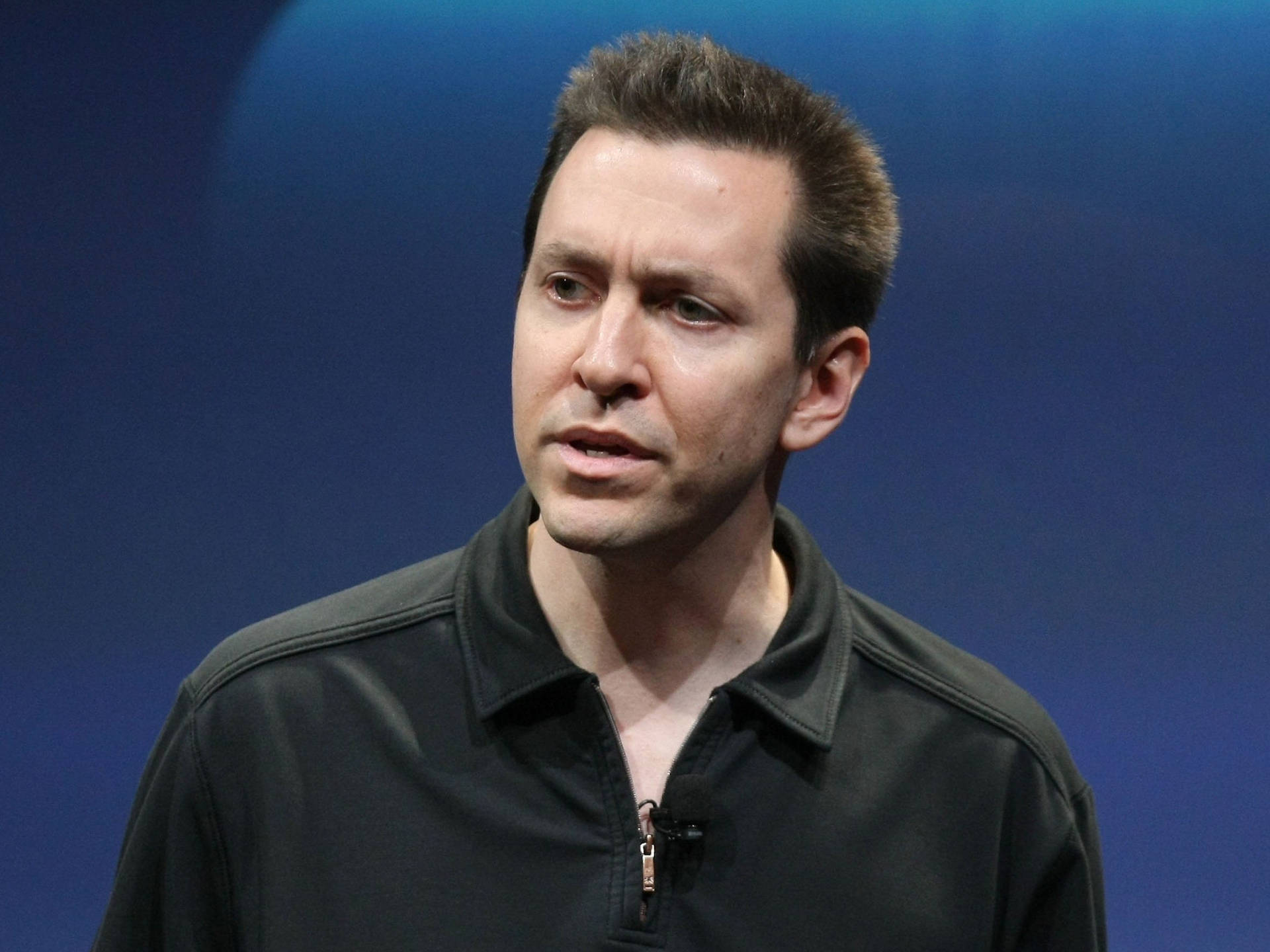 Scott Forstall Looking Thoughtful In A Presentation Wallpaper