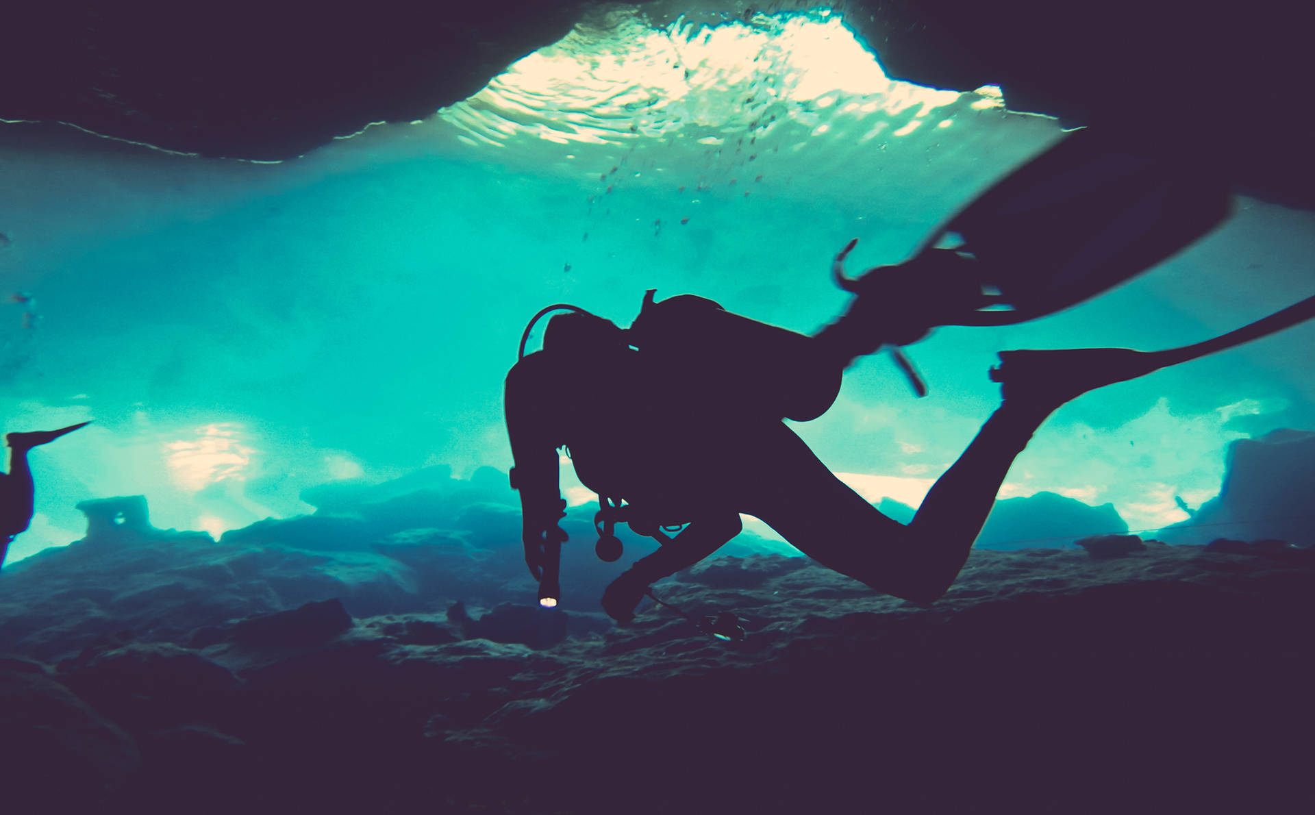 Thrilling Exploration: Scuba Diver in Underwater Cave Wallpaper