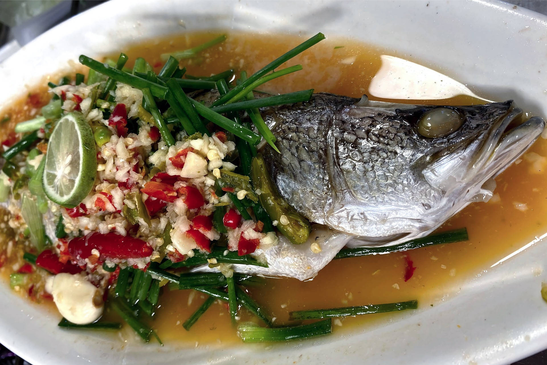 Delicious Sea Bass Soup Enhanced with Fresh Lime and Vibrant Vegetables Wallpaper