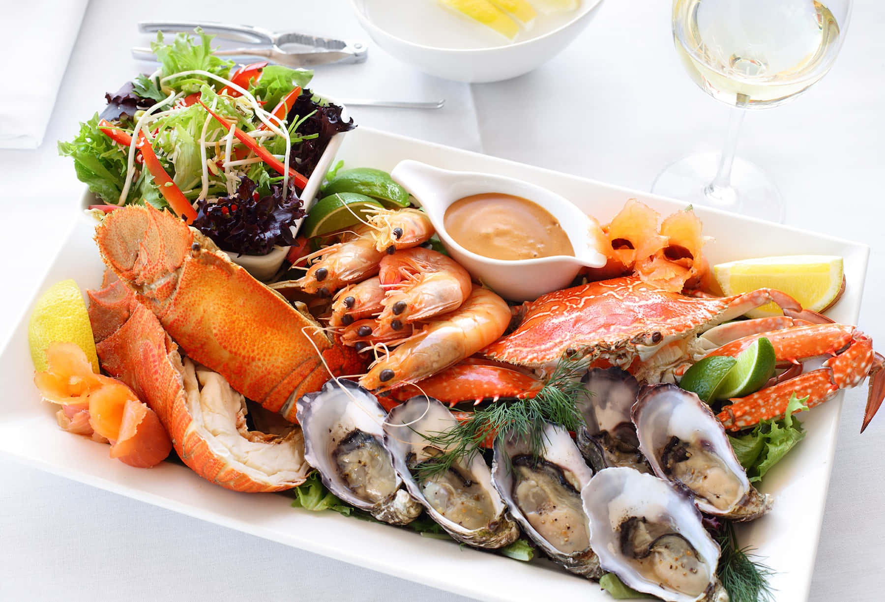 Enjoy the classic flavors of summer with a flavorful seafood platter featuring grilled salmon and steamed shrimp.