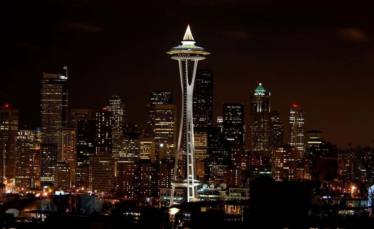 The Space Needle Is Lit Up At Night Wallpaper