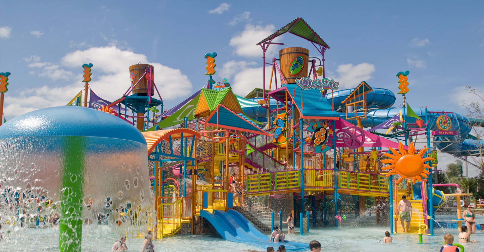 A Water Park With Many Children And A Water Slide
