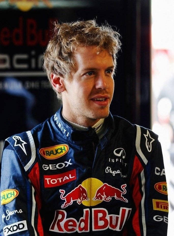 Sebastian Vettel in Intense Racing Suit Wallpaper