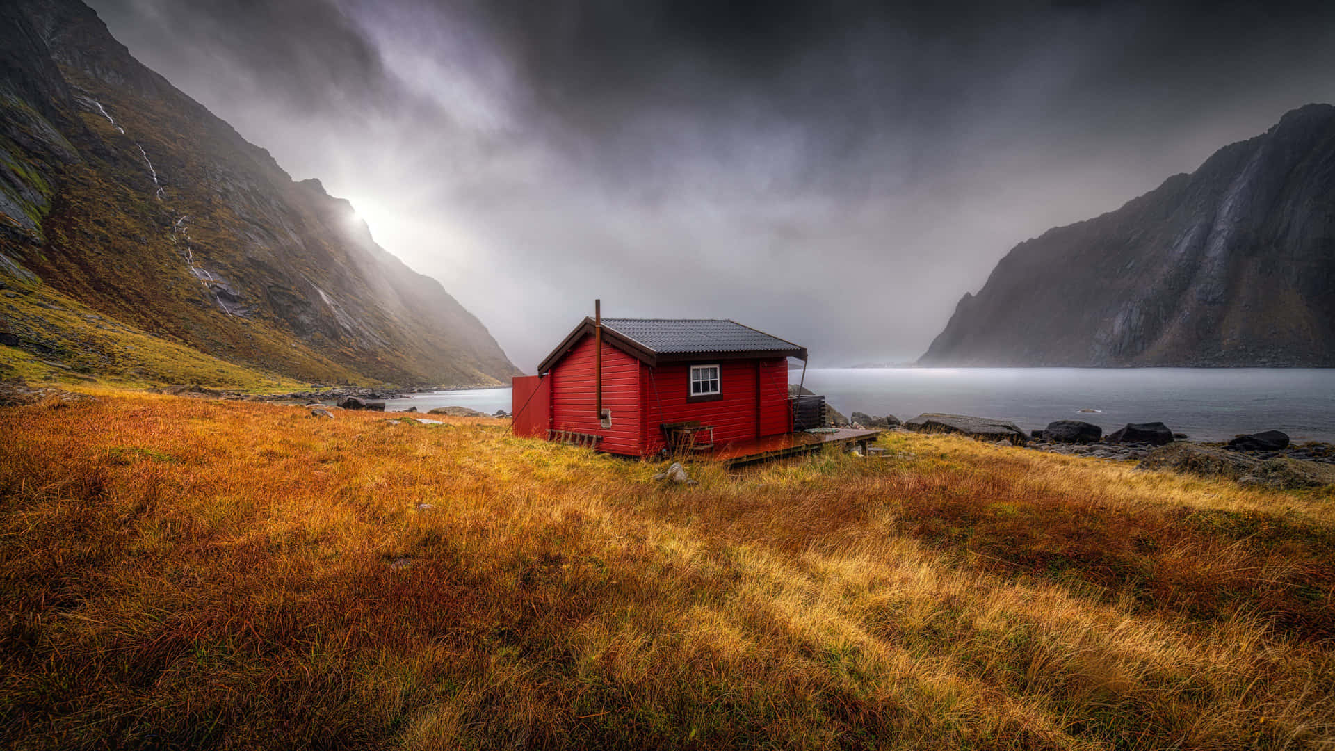 Secluded_ Red_ Cottage_by_ Mountain_ Lake Wallpaper