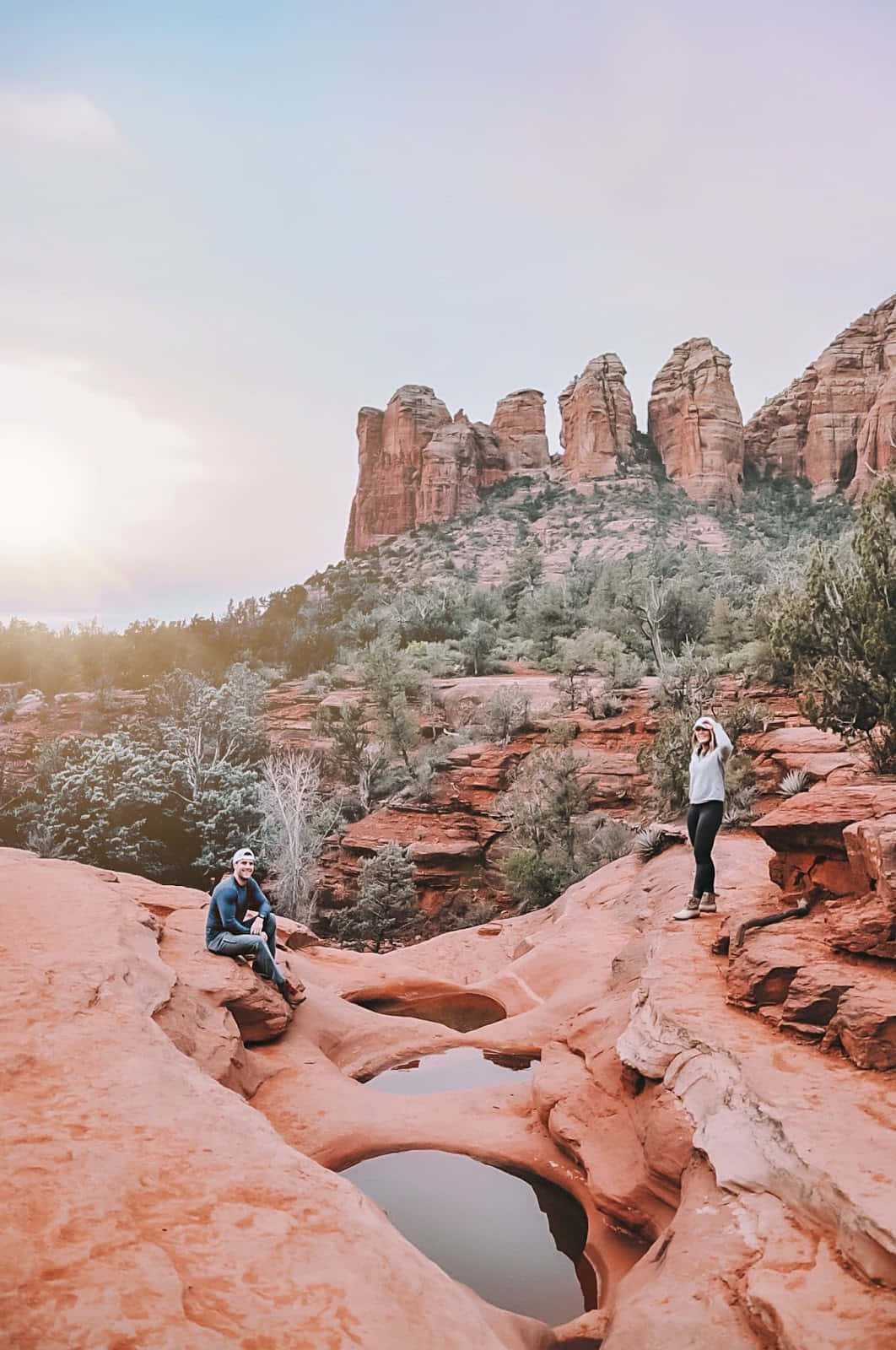 Two People Standing On Rocks In Sedona, Arizona