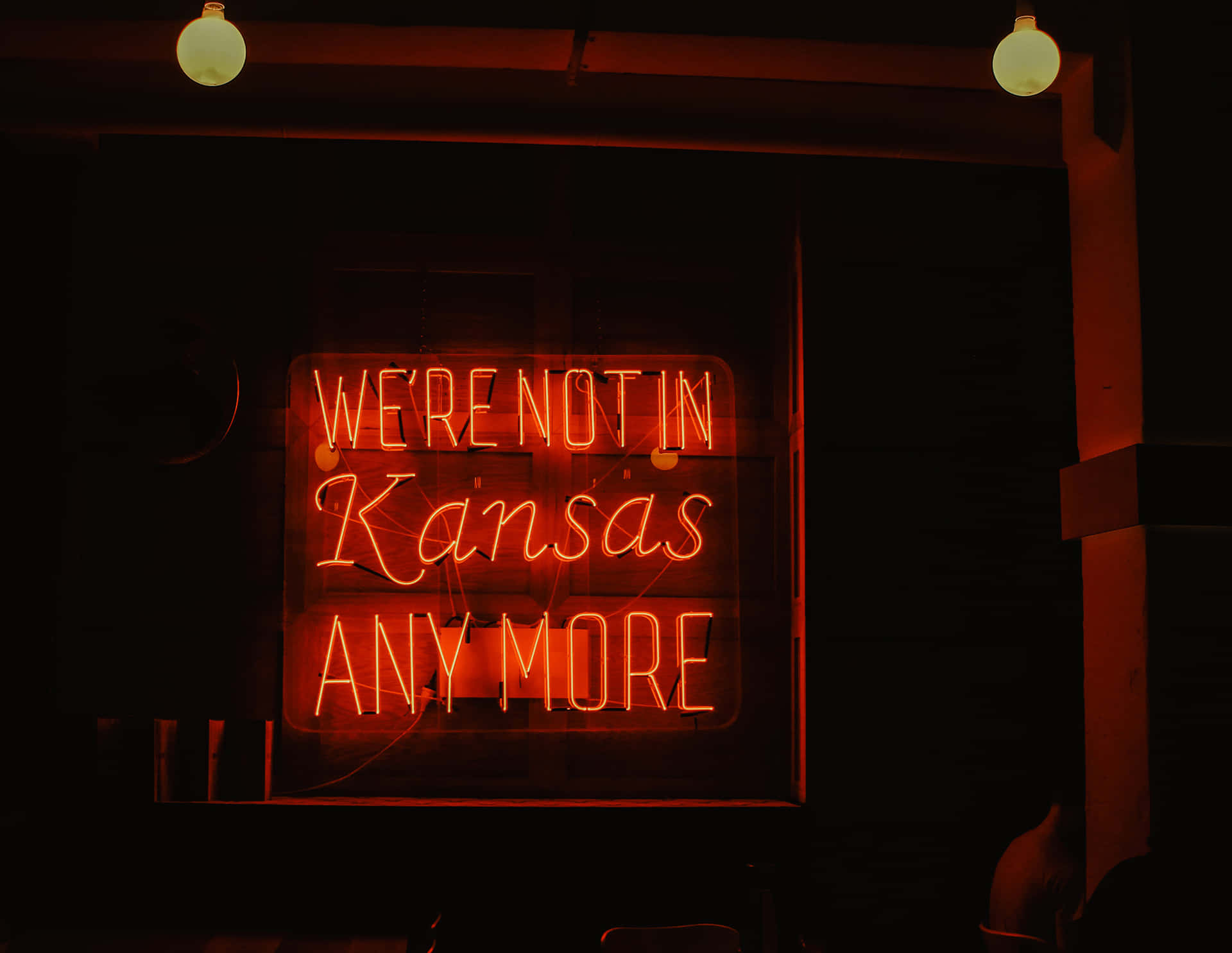 A Neon Sign That Says We're Not In Kansas Anymore Wallpaper
