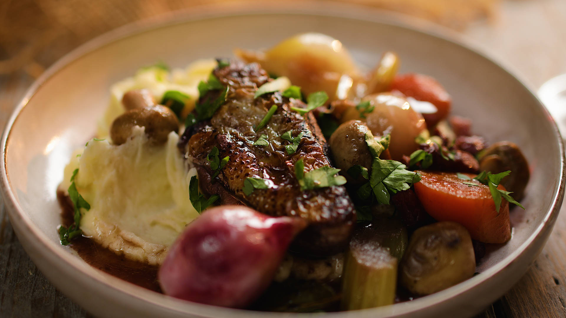 Mouthwatering Coq Au Vin Served on a Plate Wallpaper