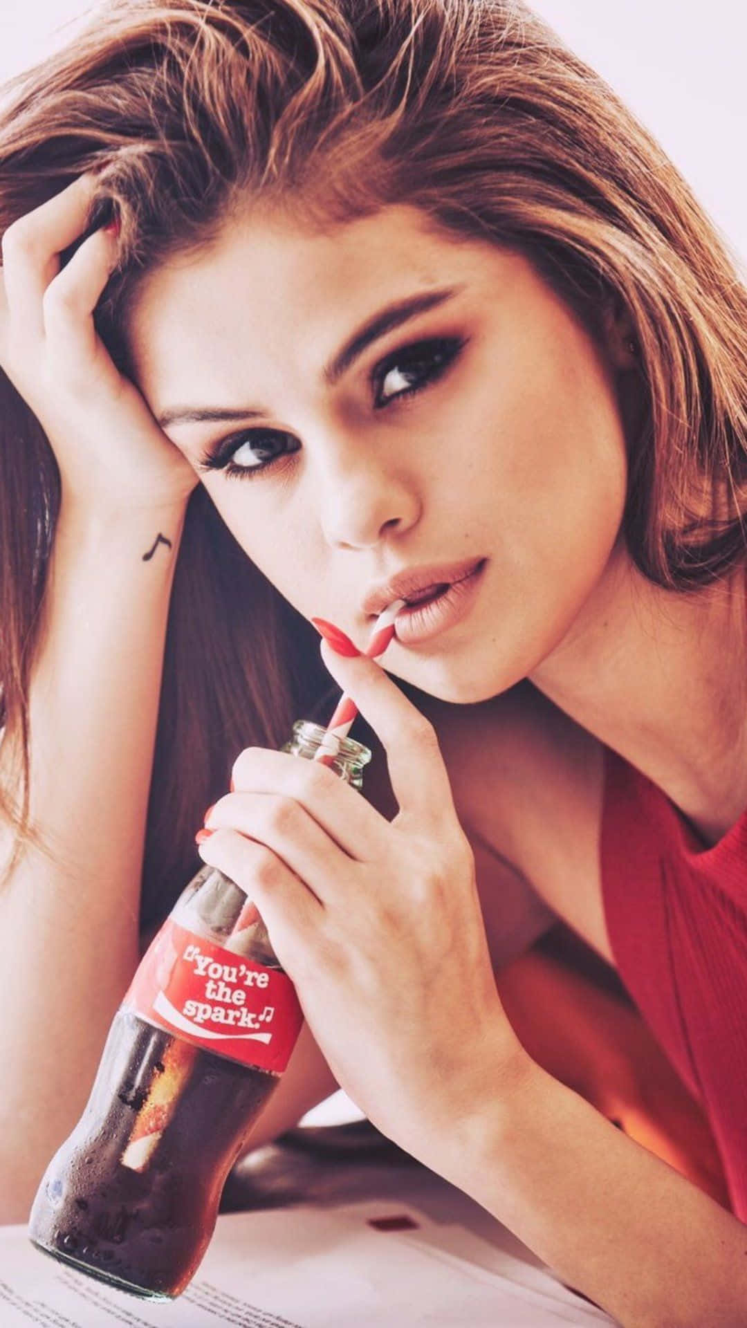 "The latest must-have accessory - Selena Gomez Iphone." Wallpaper