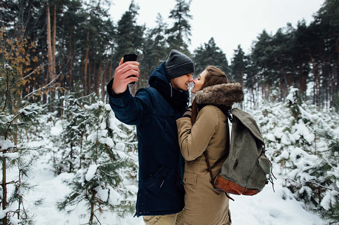 Selfie Man And Woman Couple During Winter Wallpaper