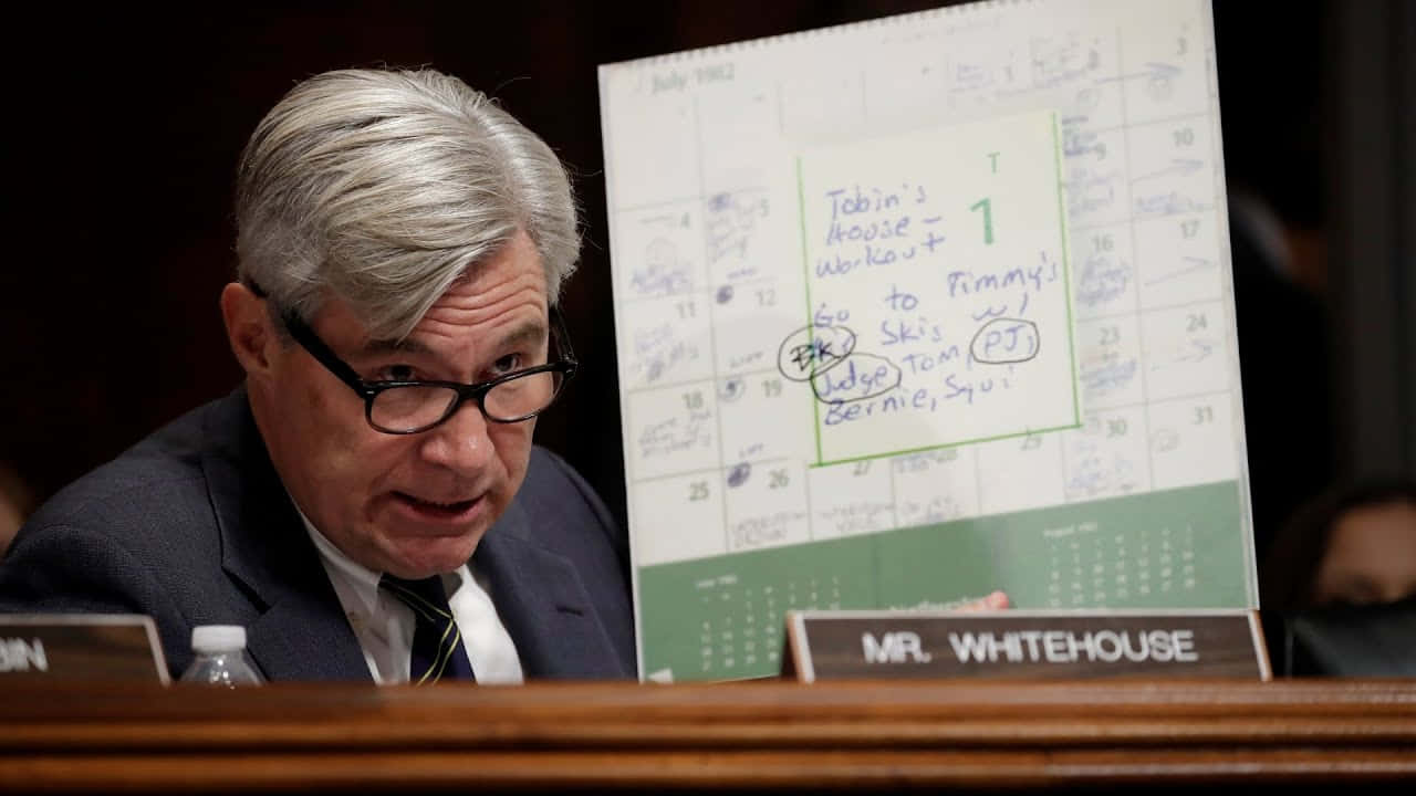 Senator Whitehouse Holding Chart During Hearing Wallpaper