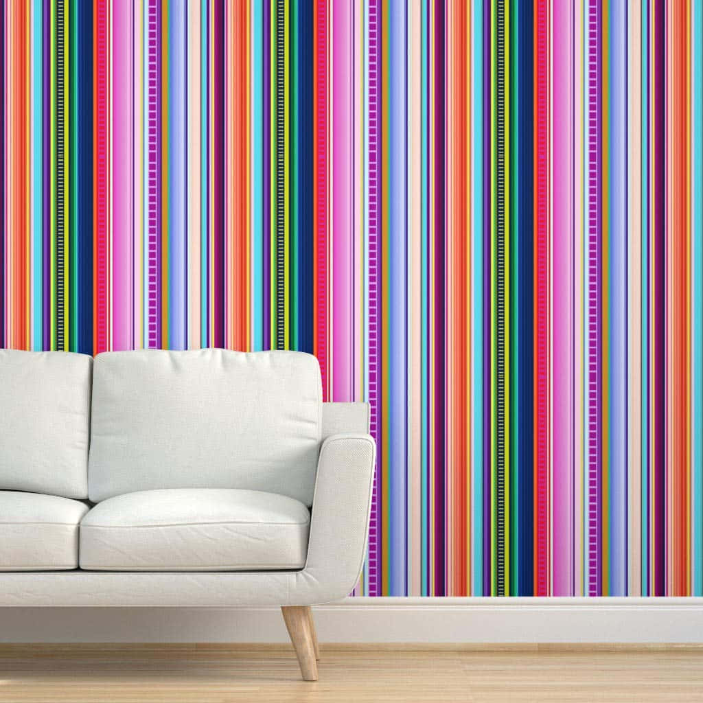 En sofa sidder foran en farverig strikket tapet. Wallpaper