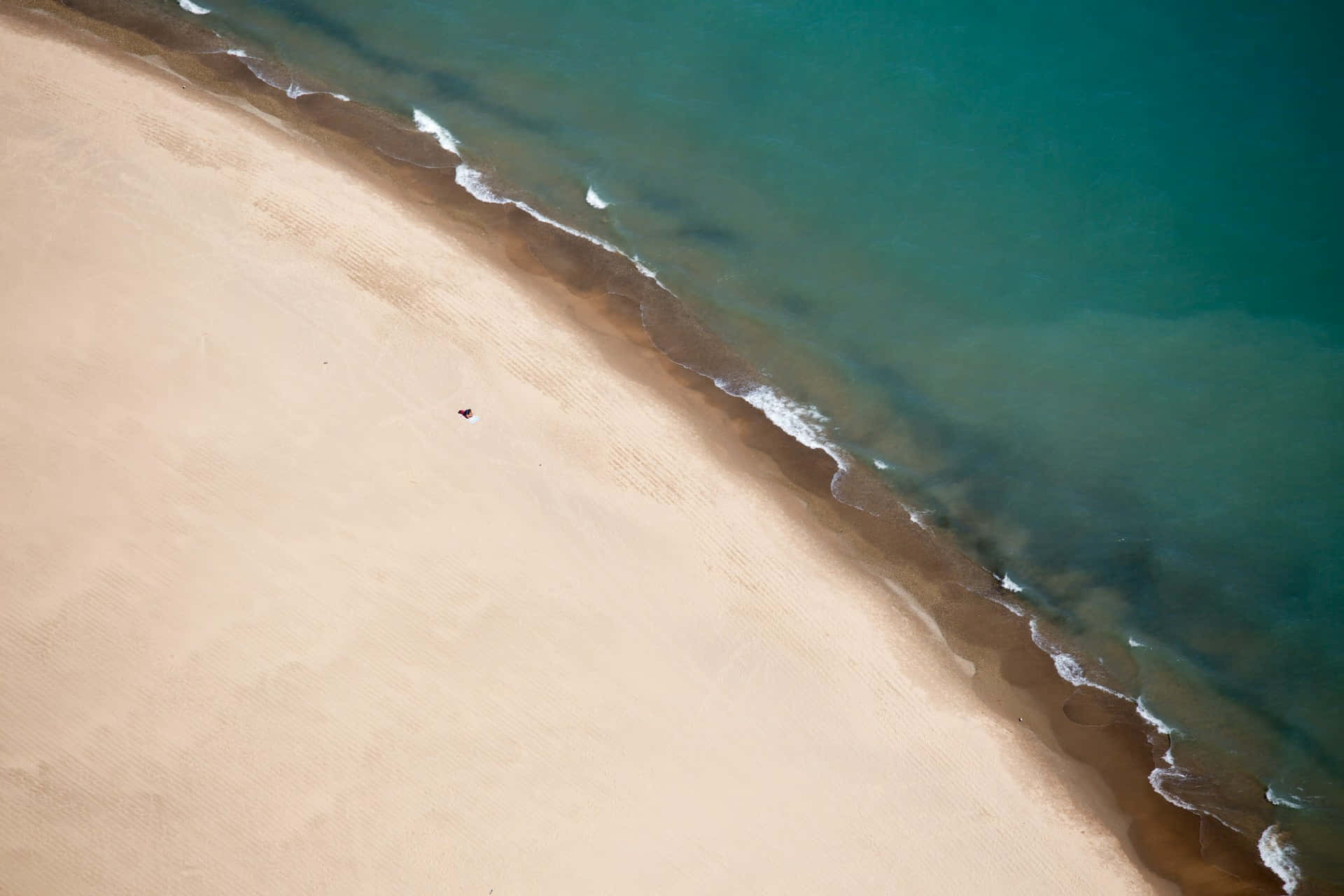 Serene Beige Beach Aerial View.jpg Wallpaper