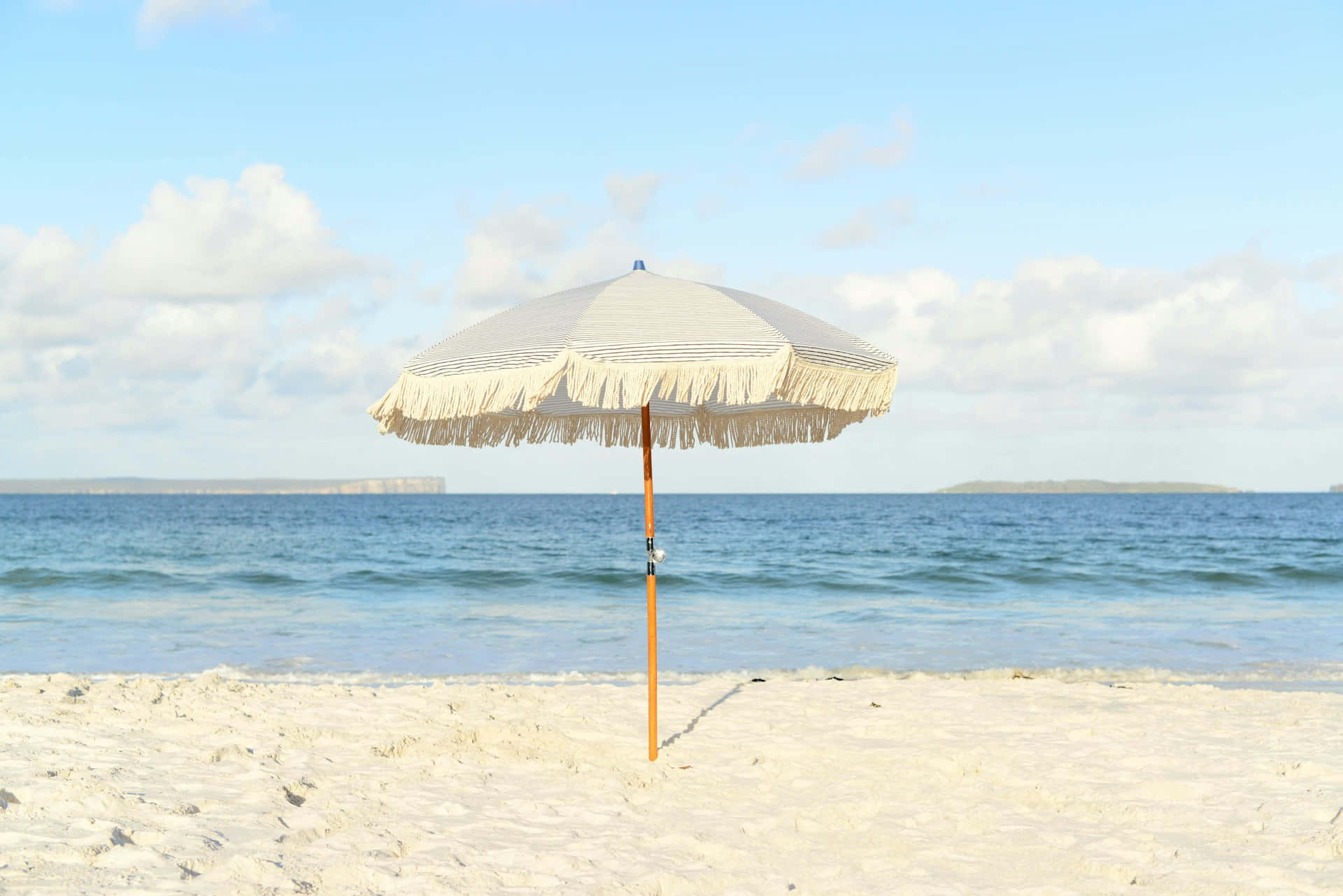 Serene Beige Beach Umbrella Wallpaper