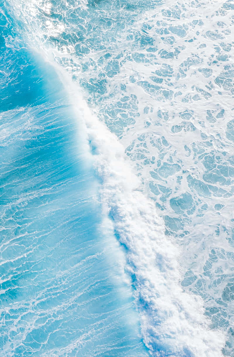 Serene Blue Ocean Wave Aerial View.jpg Wallpaper