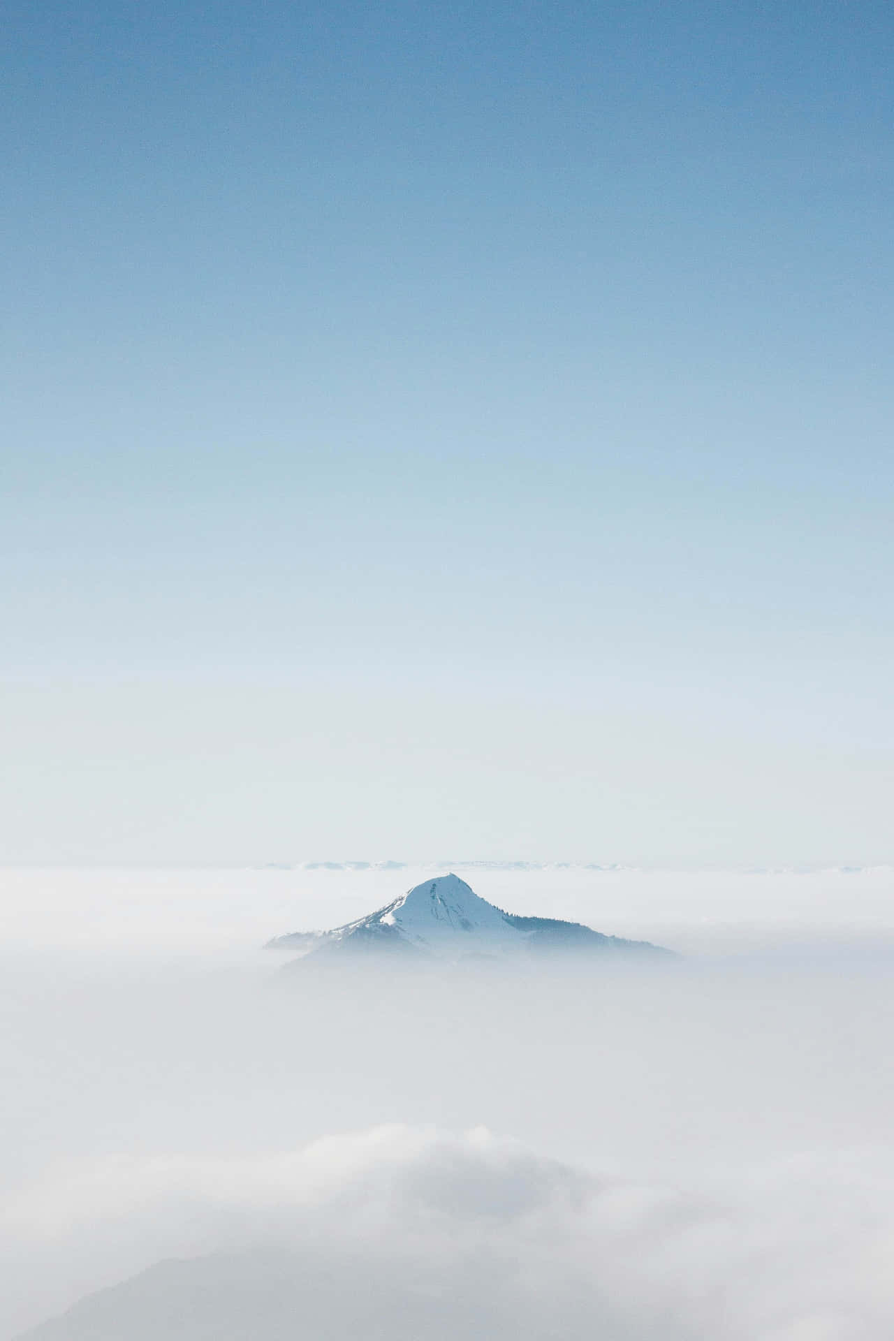 Serene Mountain Peak Above Clouds Wallpaper
