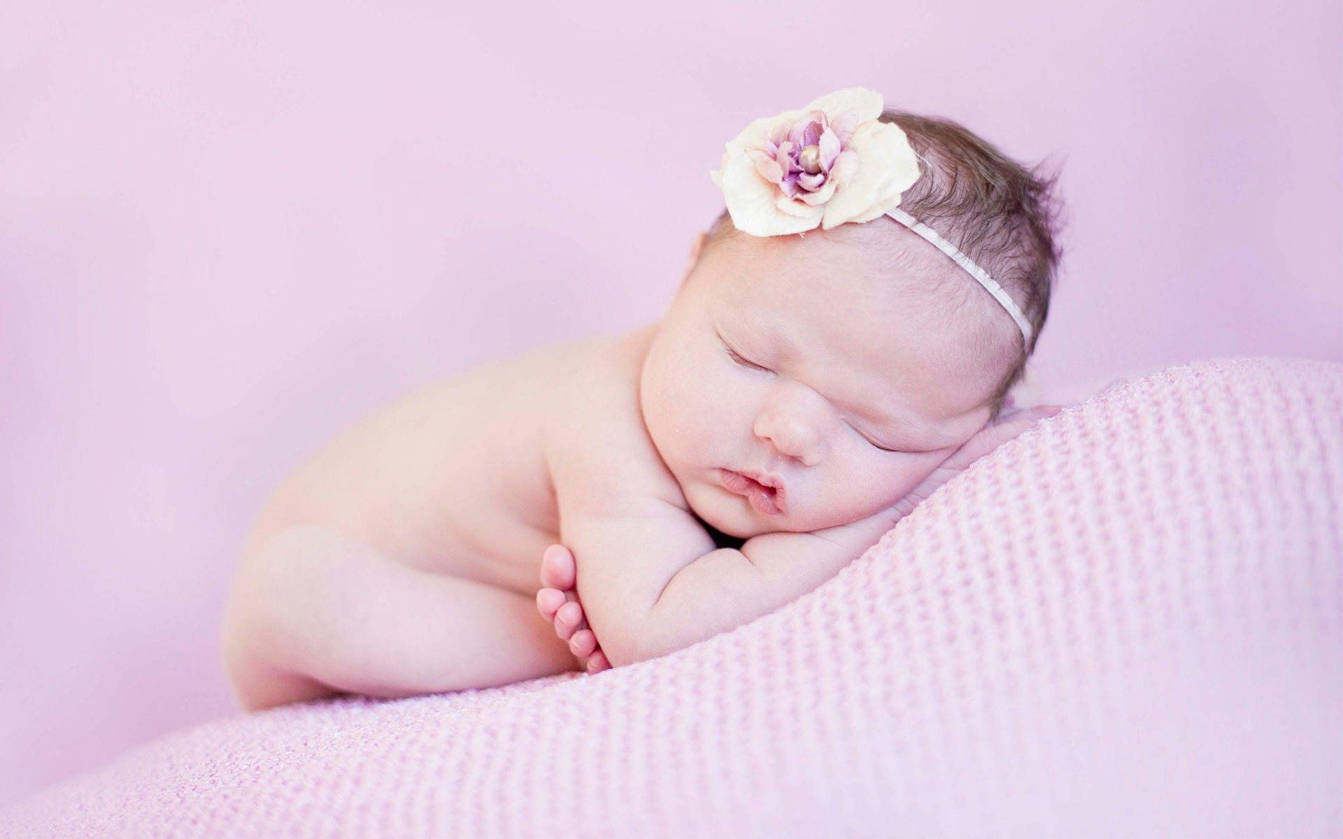 Serene Newborn Sleeping Peacefully Wallpaper