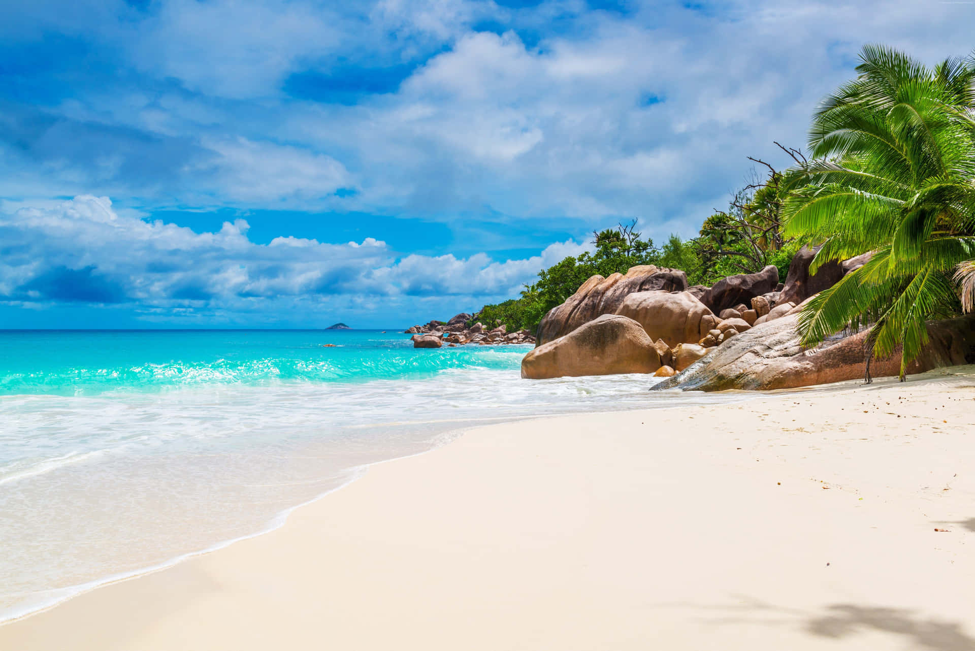 Caption: Pristine Seychelles Beach on a Sunny Day Wallpaper