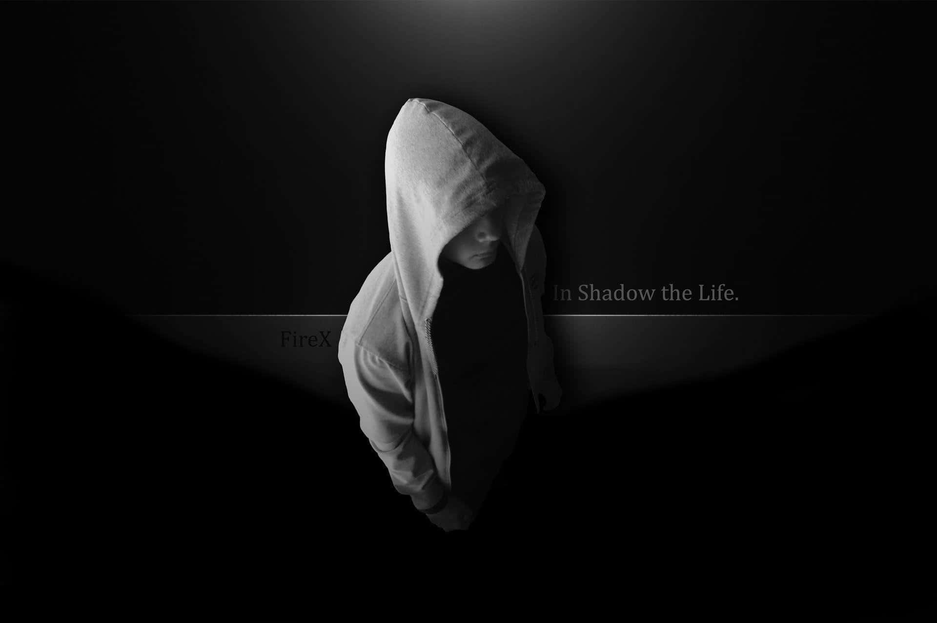 A Man In A Hoodie Standing In The Dark