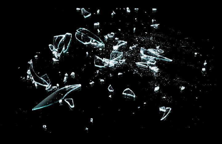 Shattered Glass Fragments Against Black Background PNG