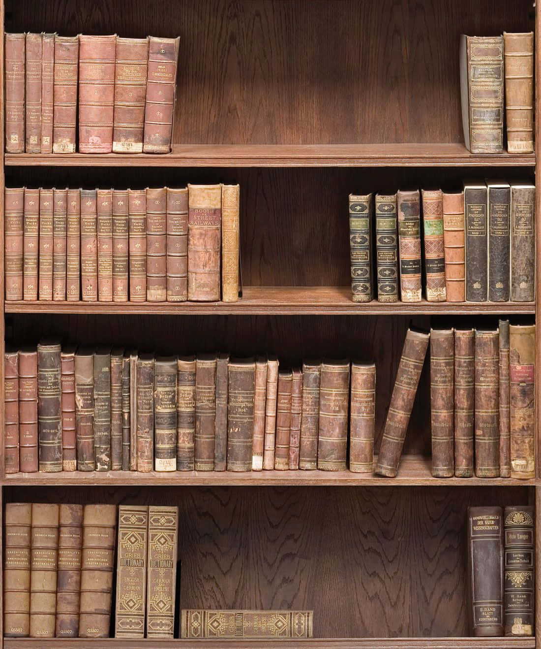 A Wooden Bookcase With Many Old Books