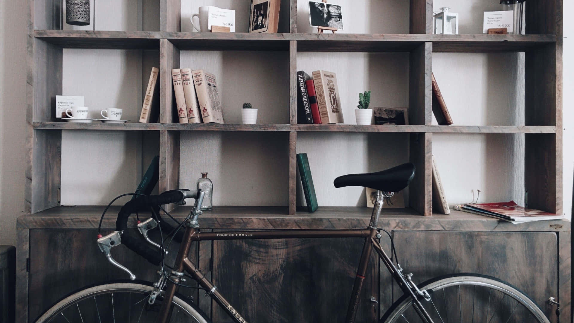 A Bicycle Is Parked In Front Of A Bookcase