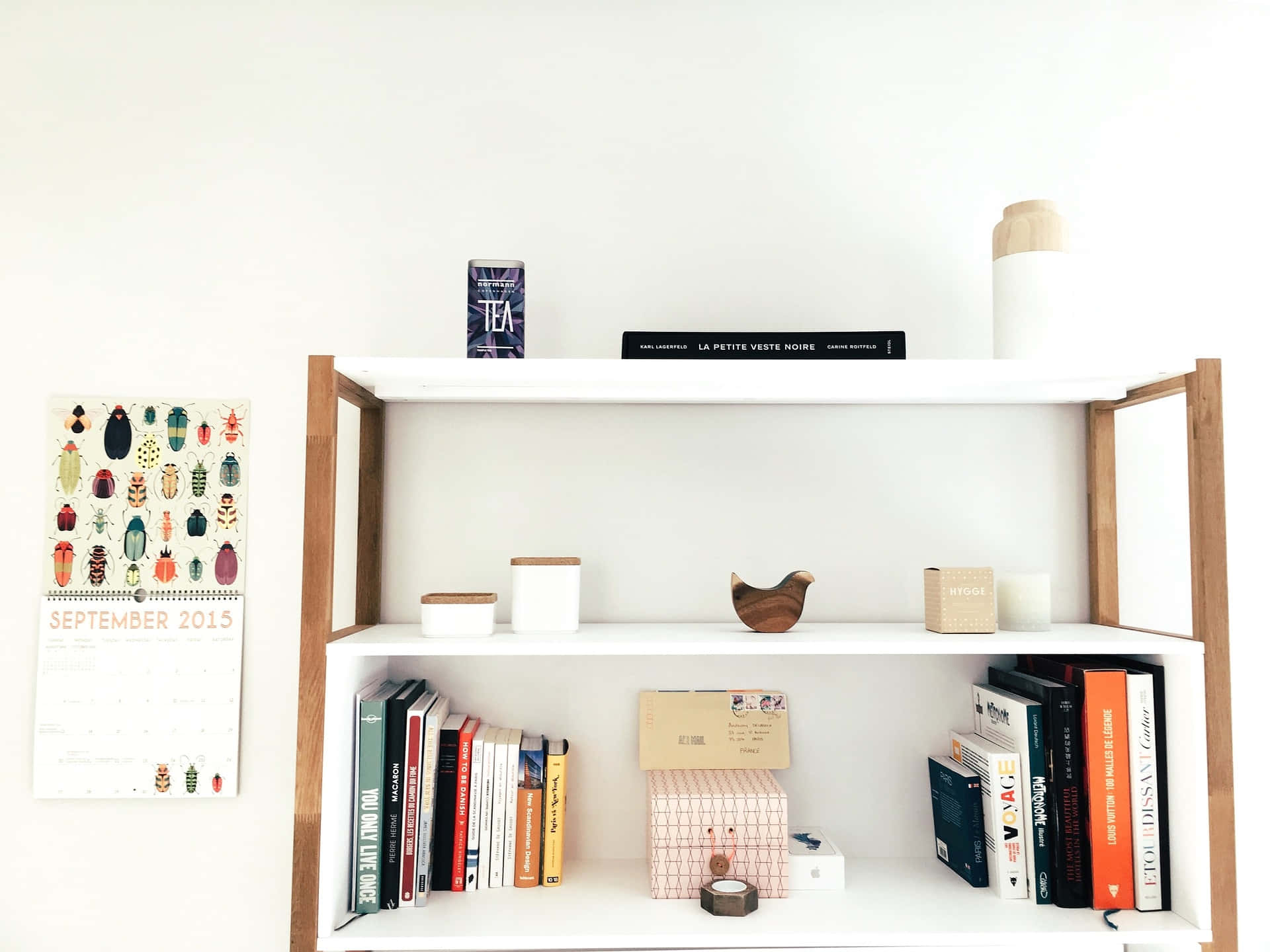A White Shelf With Books And A Clock