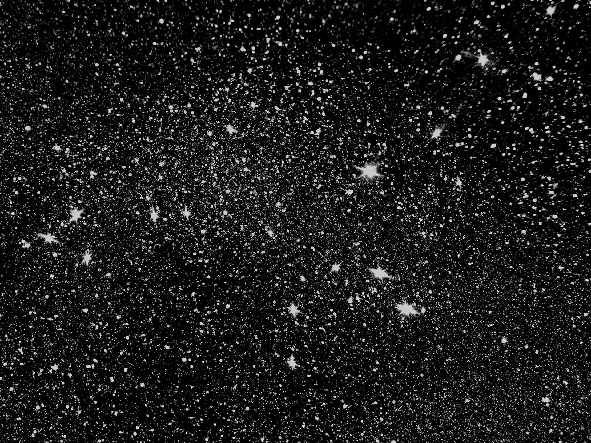 A Black And White Photo Of A Cluster Of Stars