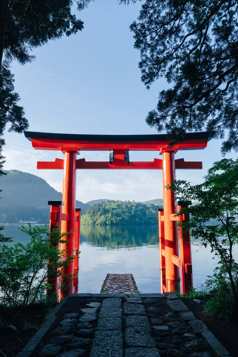 A serene Shinto shrine surrounded by nature Wallpaper