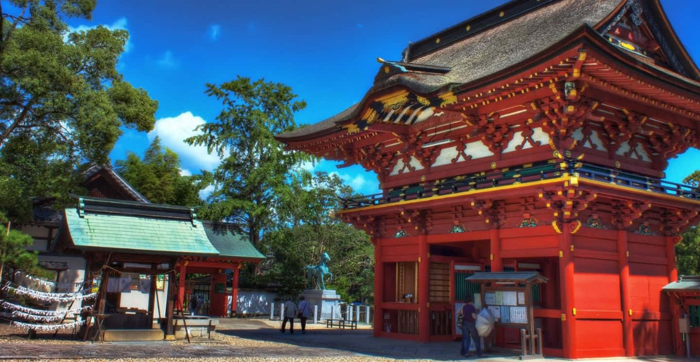 Shinto Shrine Gate (Torii) Amidst a Lush Forest Wallpaper