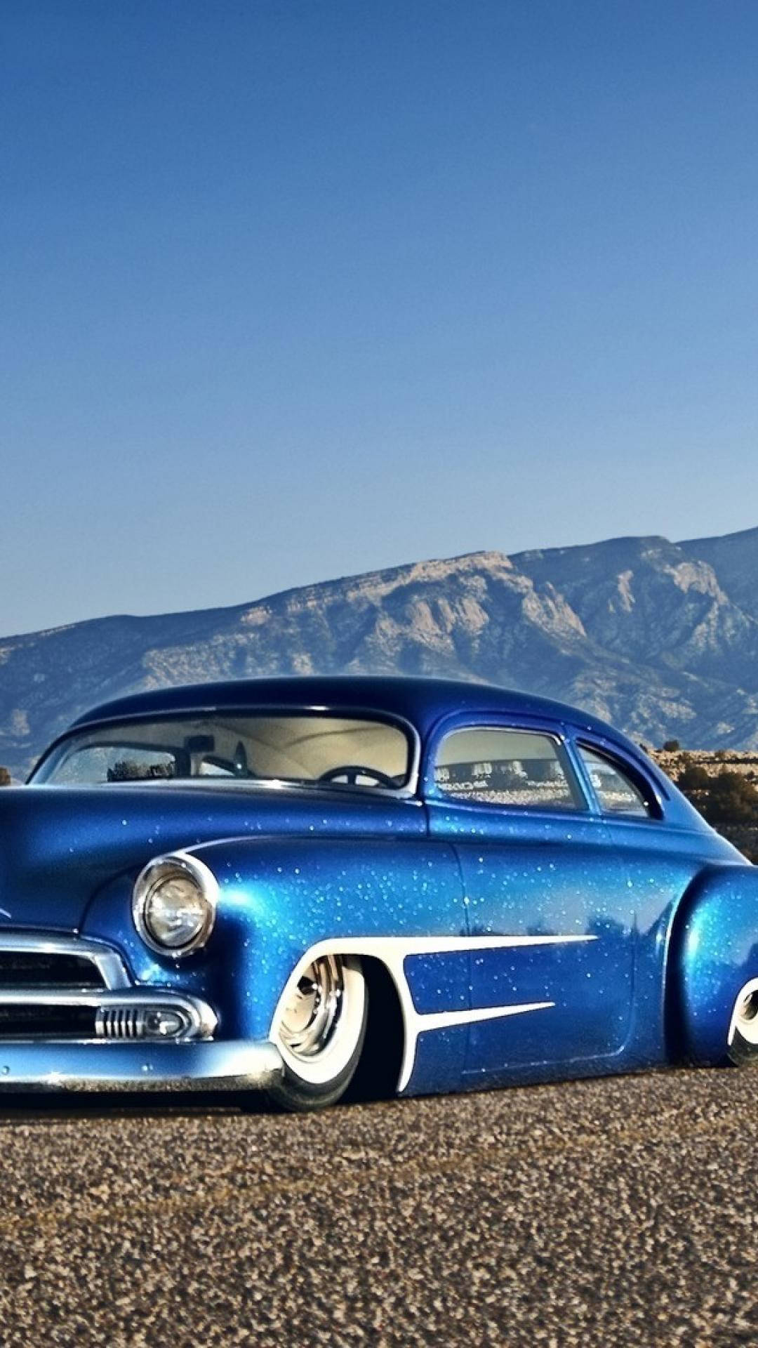 Shiny Blue Car Mountains Phone Wallpaper