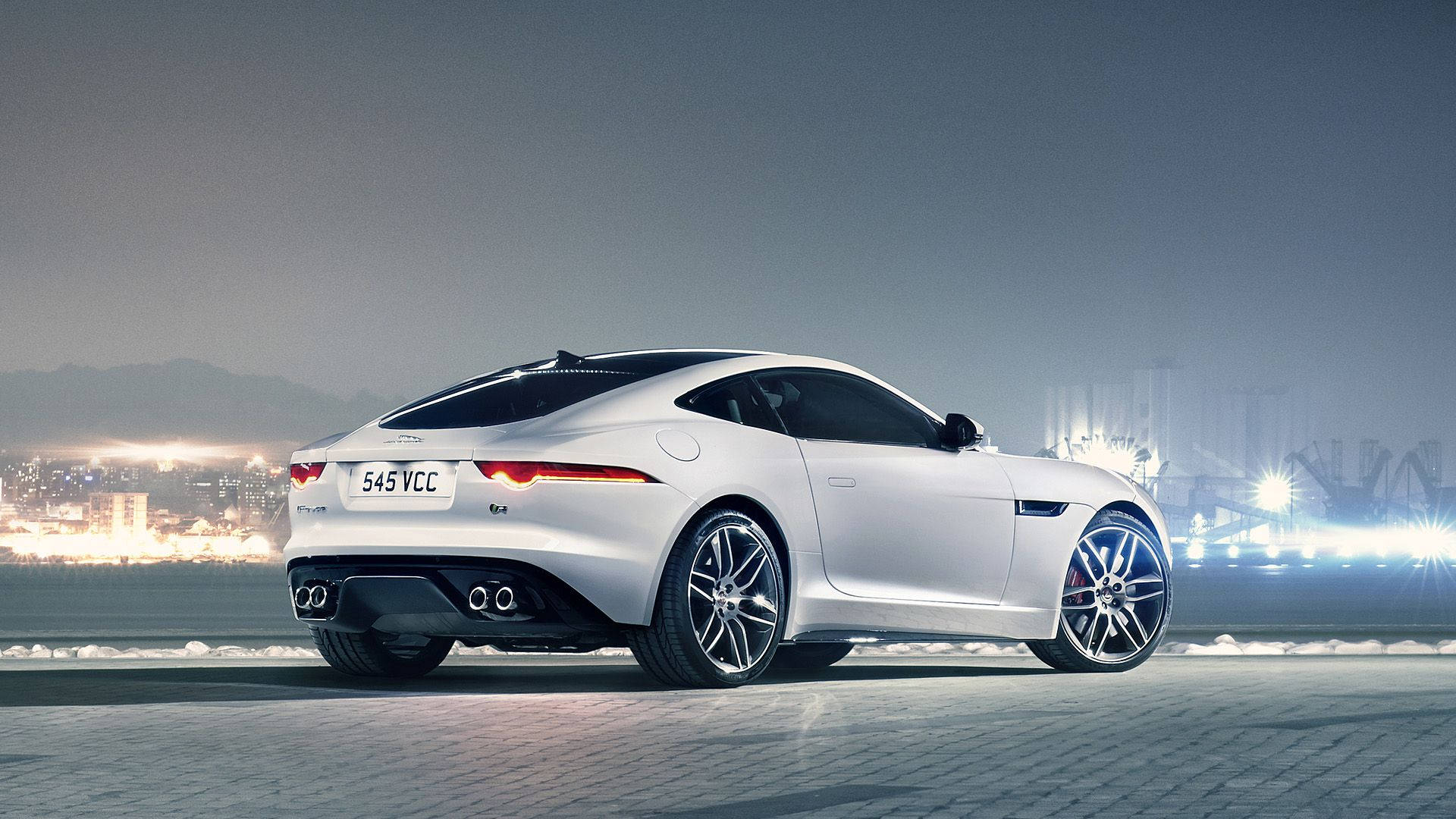 Speed into the night with this sleek, silver Jaguar car Wallpaper