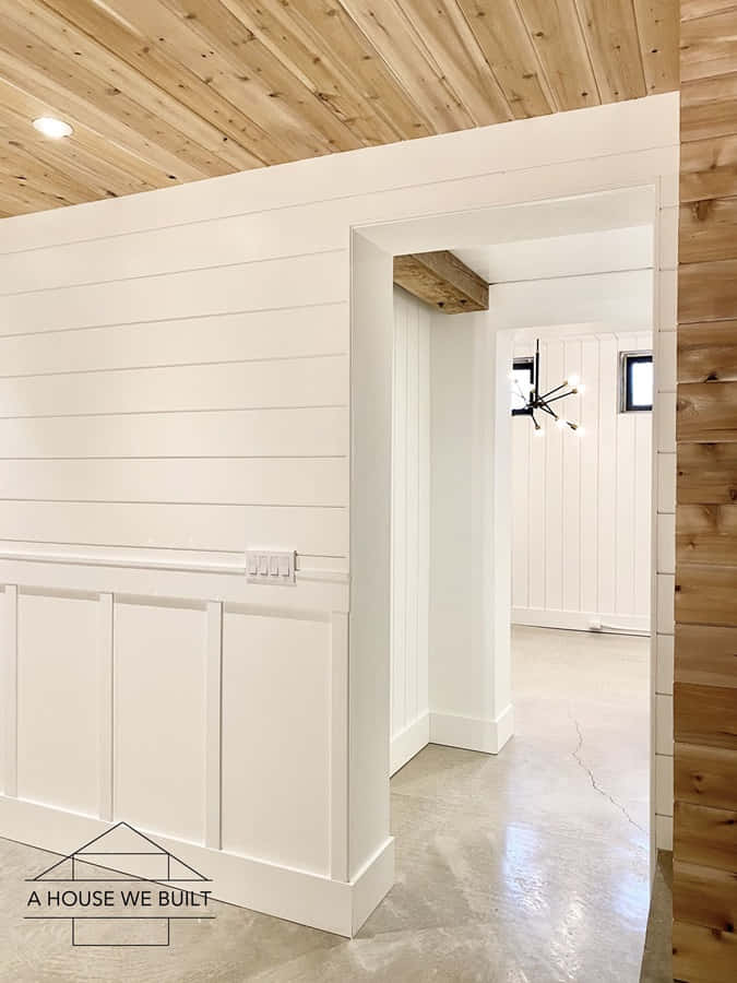 A White Room With Wood Paneling And A Door