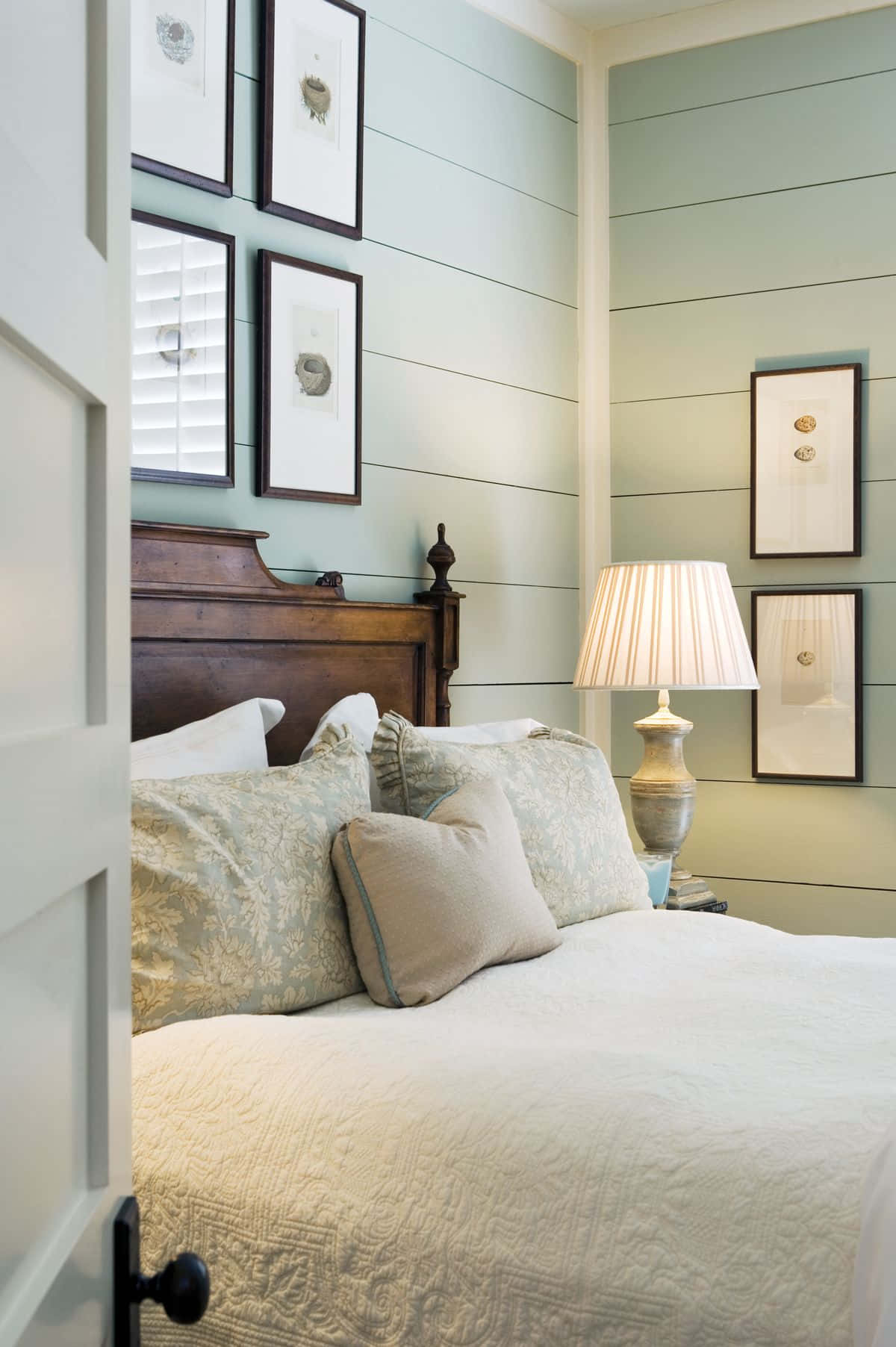 A Bedroom With A White Bed And A White Headboard