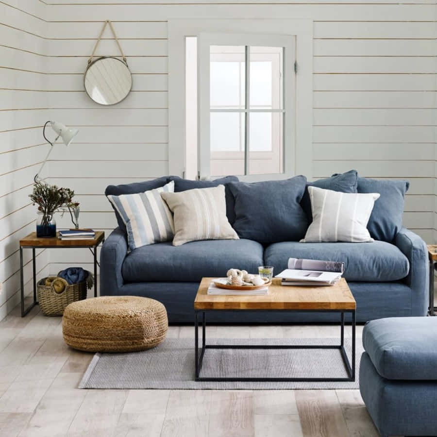 A Living Room With A Blue Couch And Wooden Floors