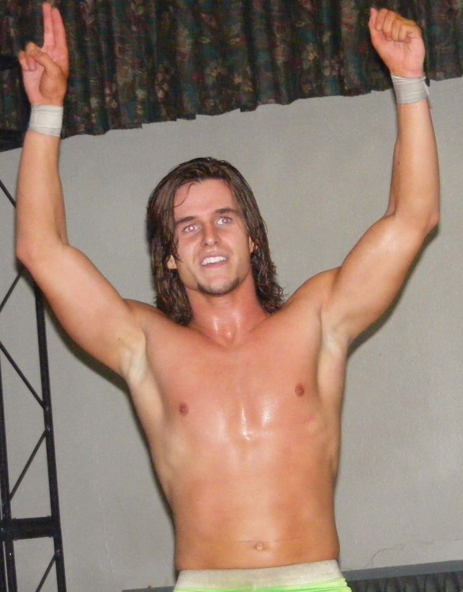 Shirtless Young Adam Cole With His Hands Up Wallpaper