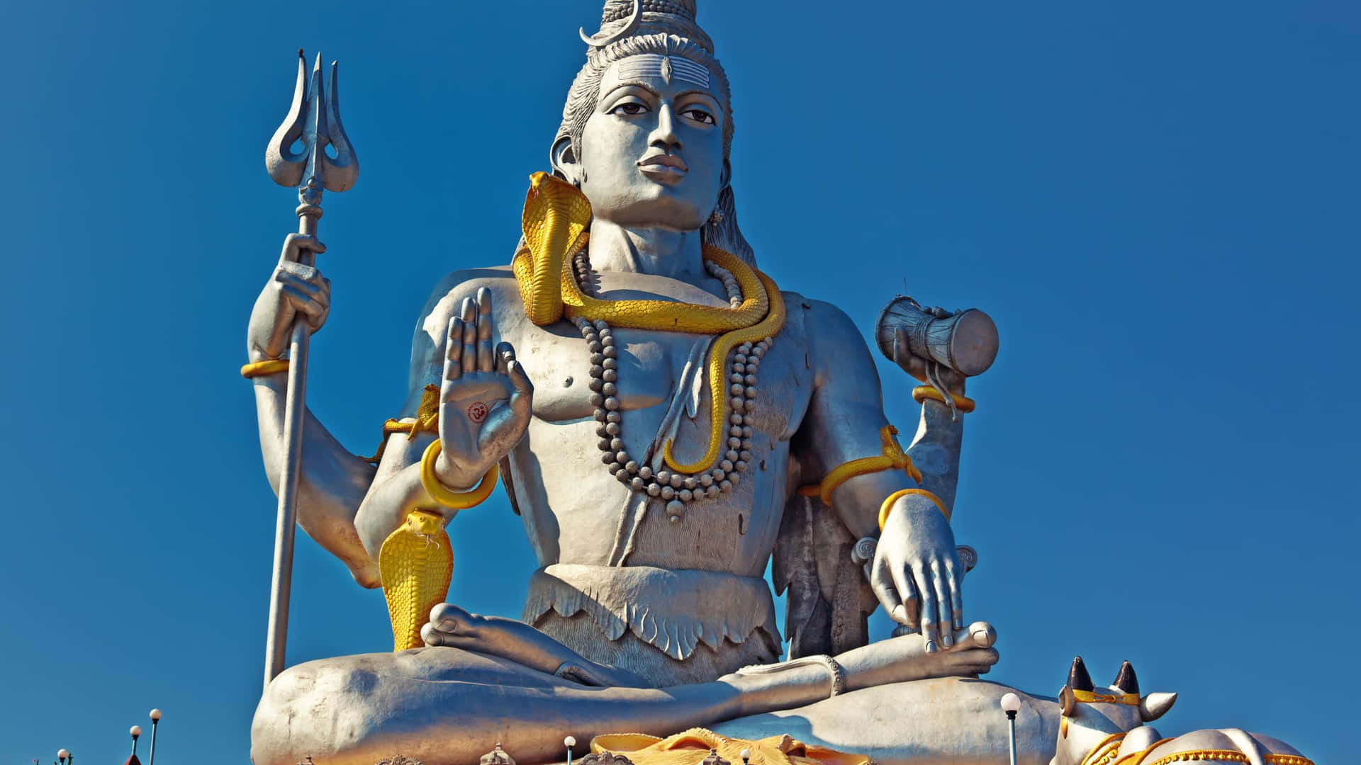 A Large Statue Of Lord Shiva Is In The Middle Of A Field