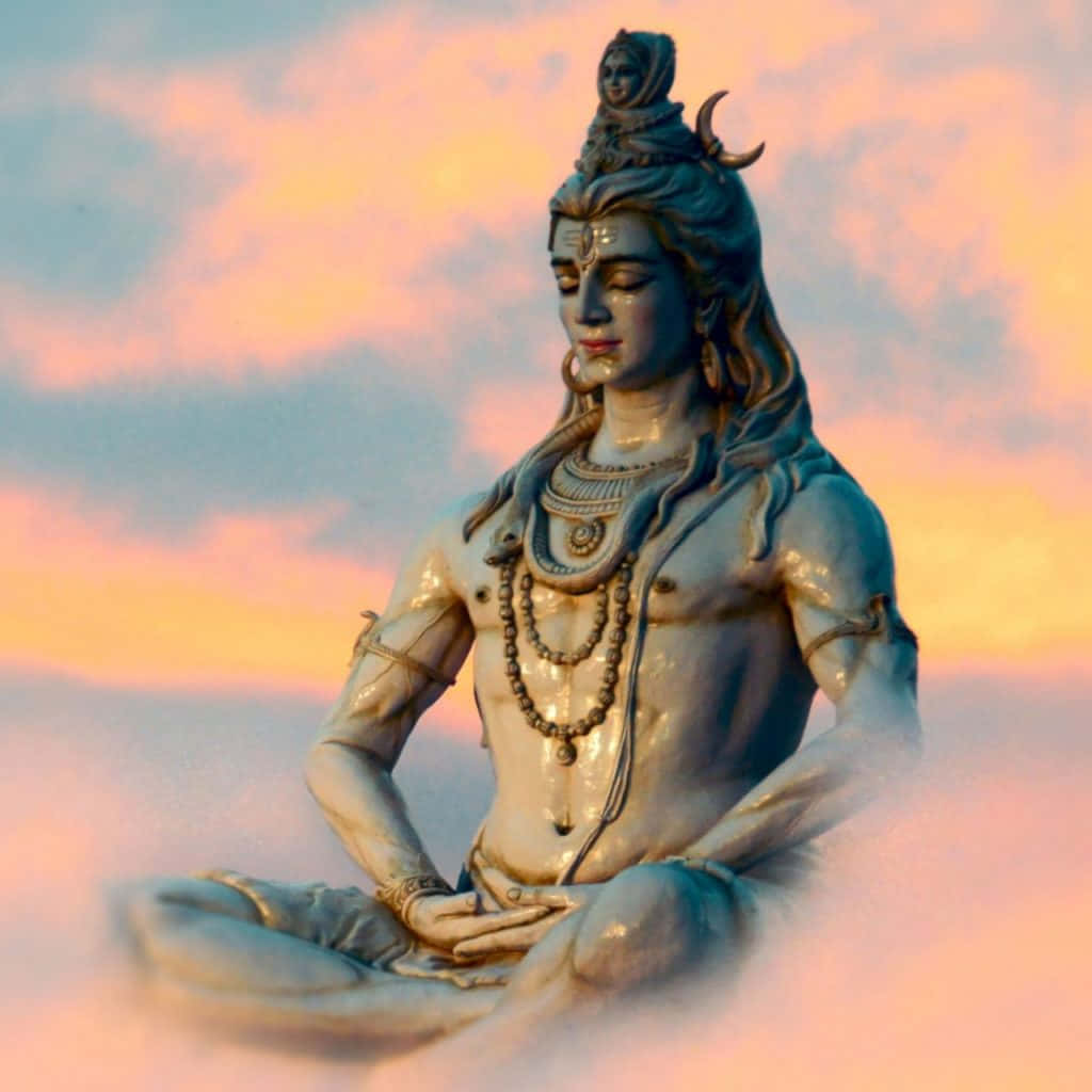 A Statue Of Lord Shiva Sitting In The Clouds
