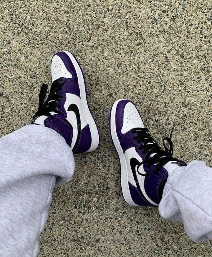 A Person Wearing Purple And White Sneakers