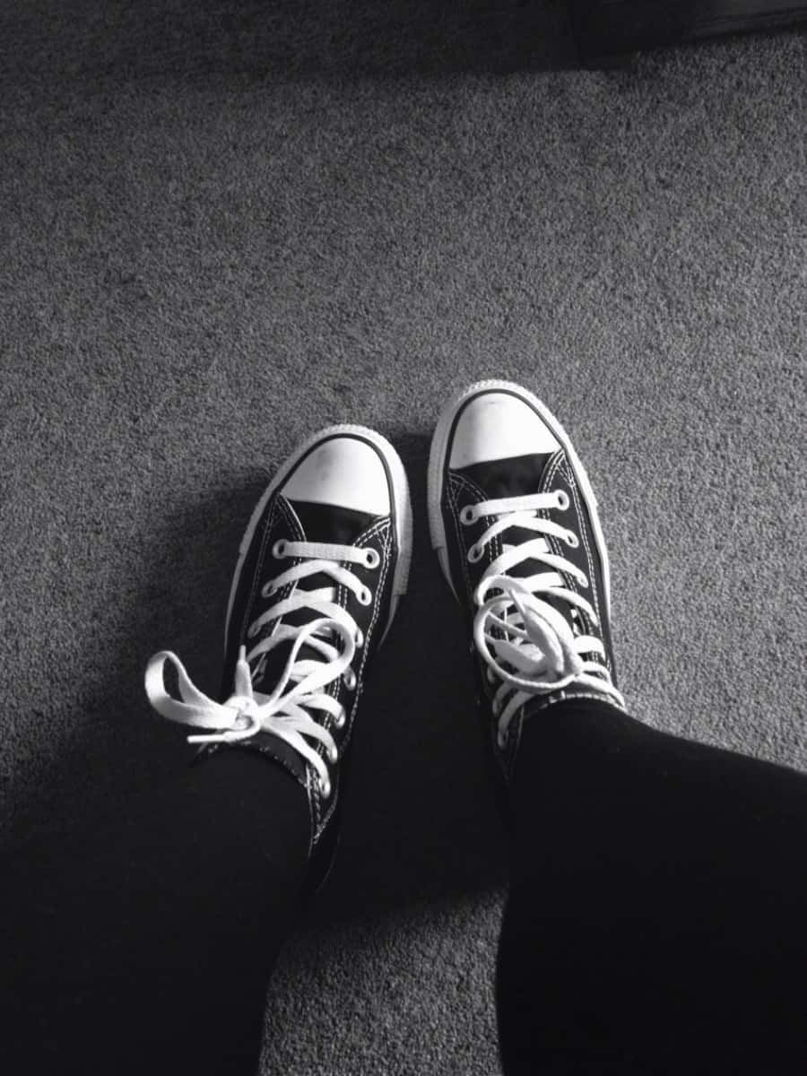 Black And White Photo Of A Person Wearing Converse