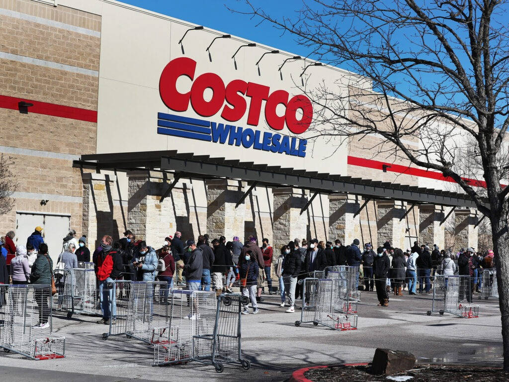 Shoppers Lining Outside Costco Store Wallpaper