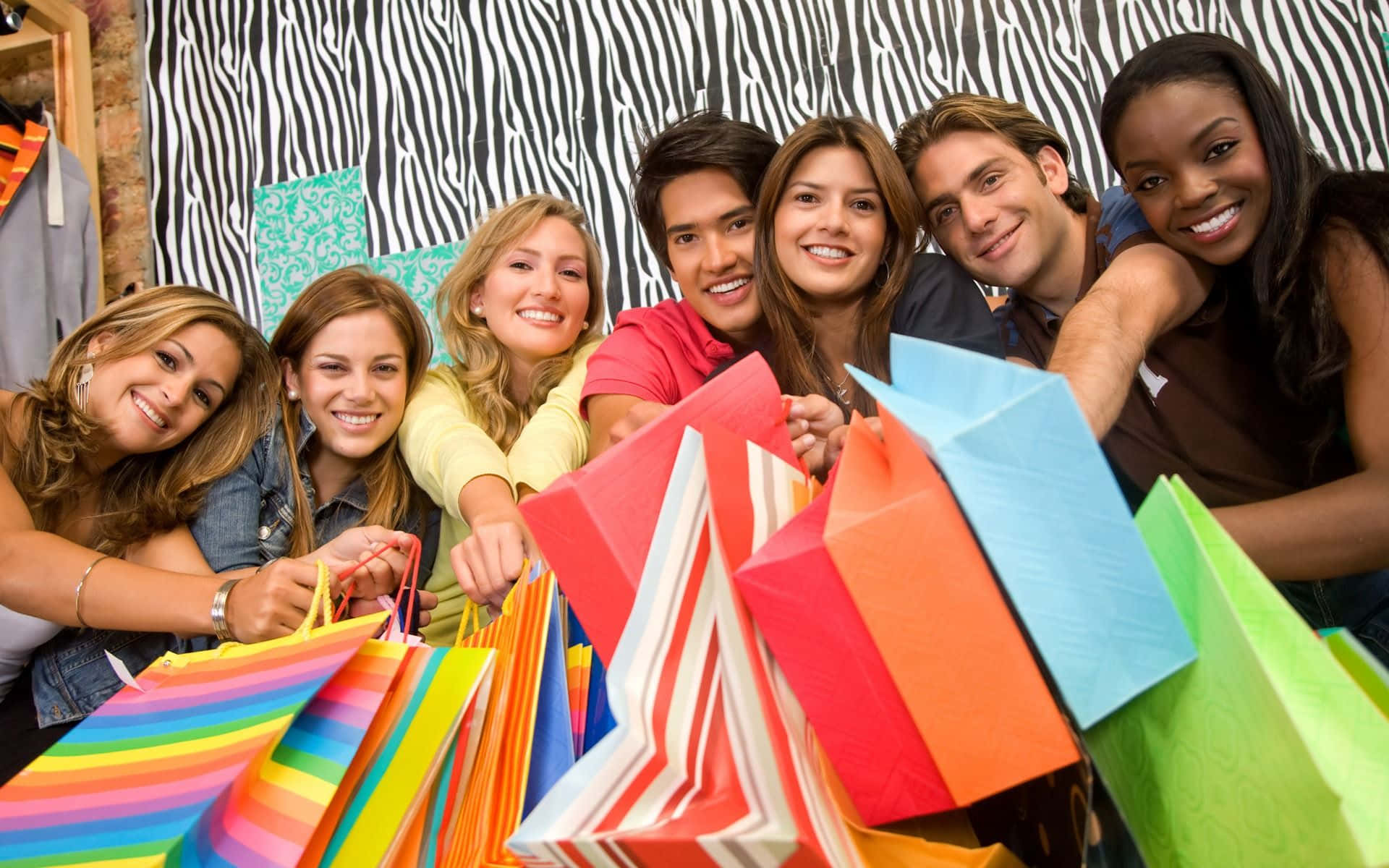 Download A Group Of People Holding Shopping Bags | Wallpapers.com