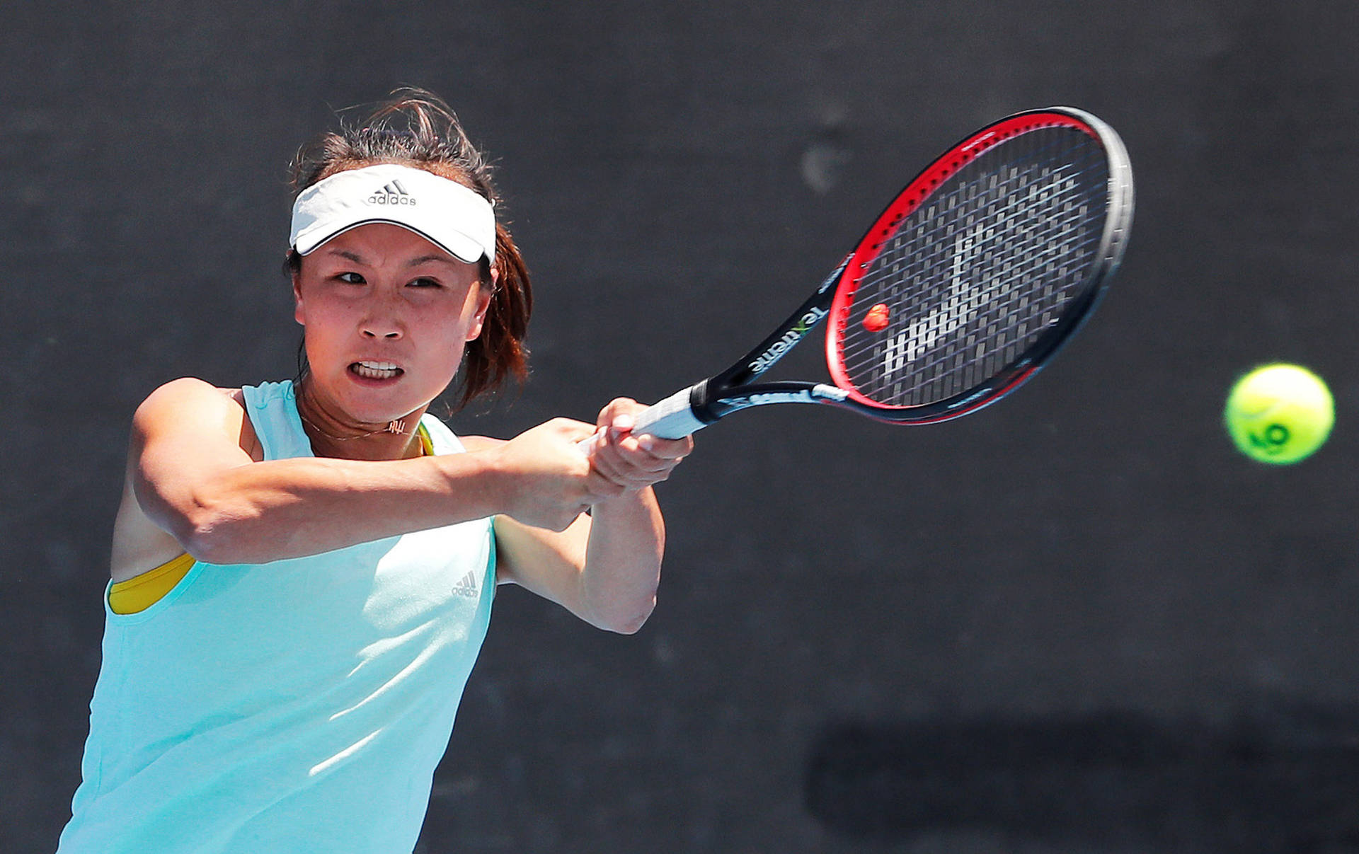 Shuai Peng shining in bright sunlight during a professional tennis match Wallpaper