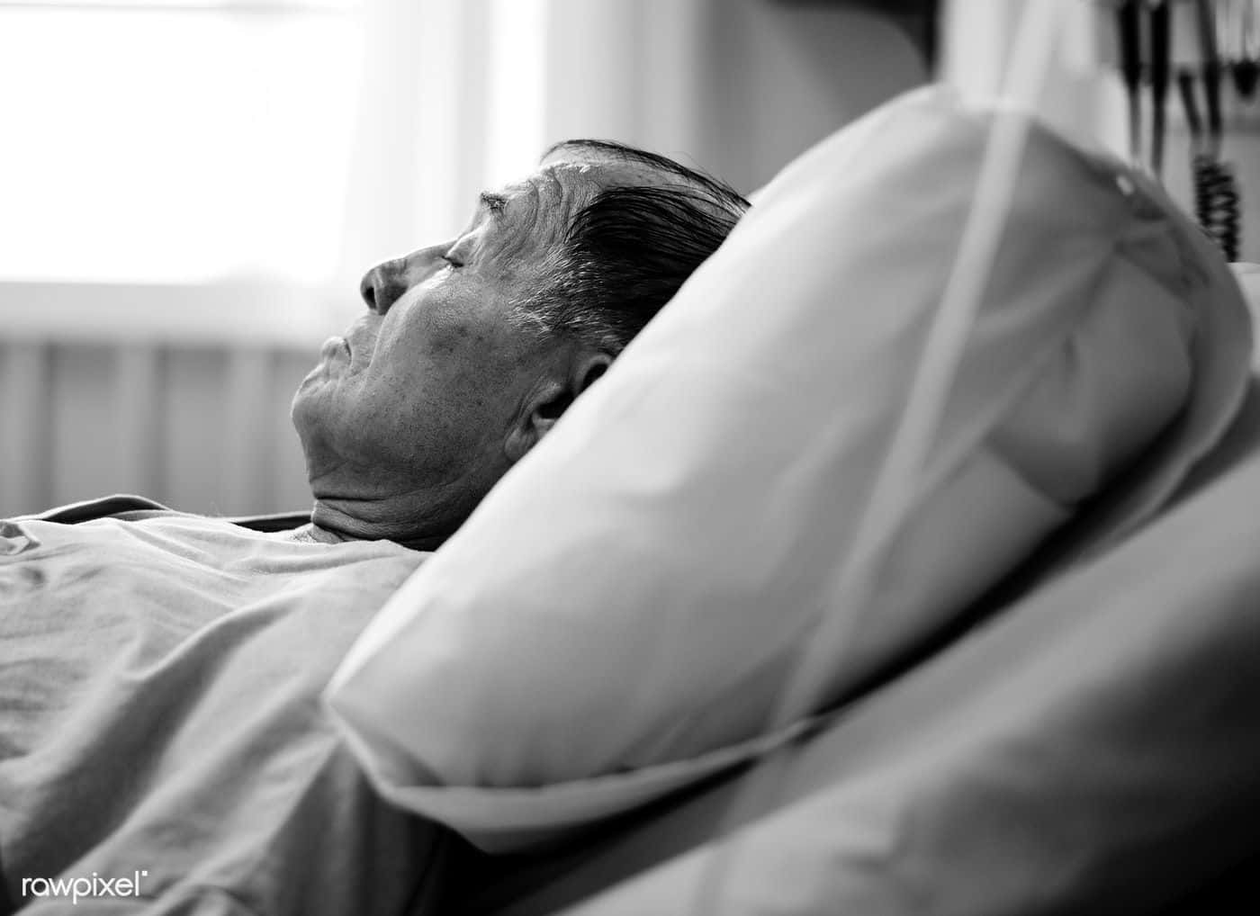 A Man In A Hospital Bed