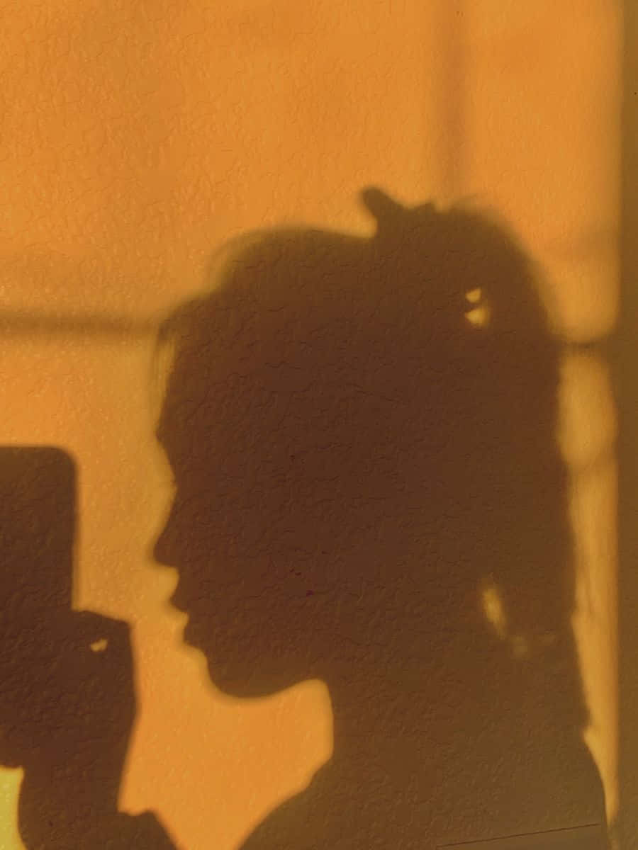 Intriguing Side Profile of a Woman's Shadow Wallpaper