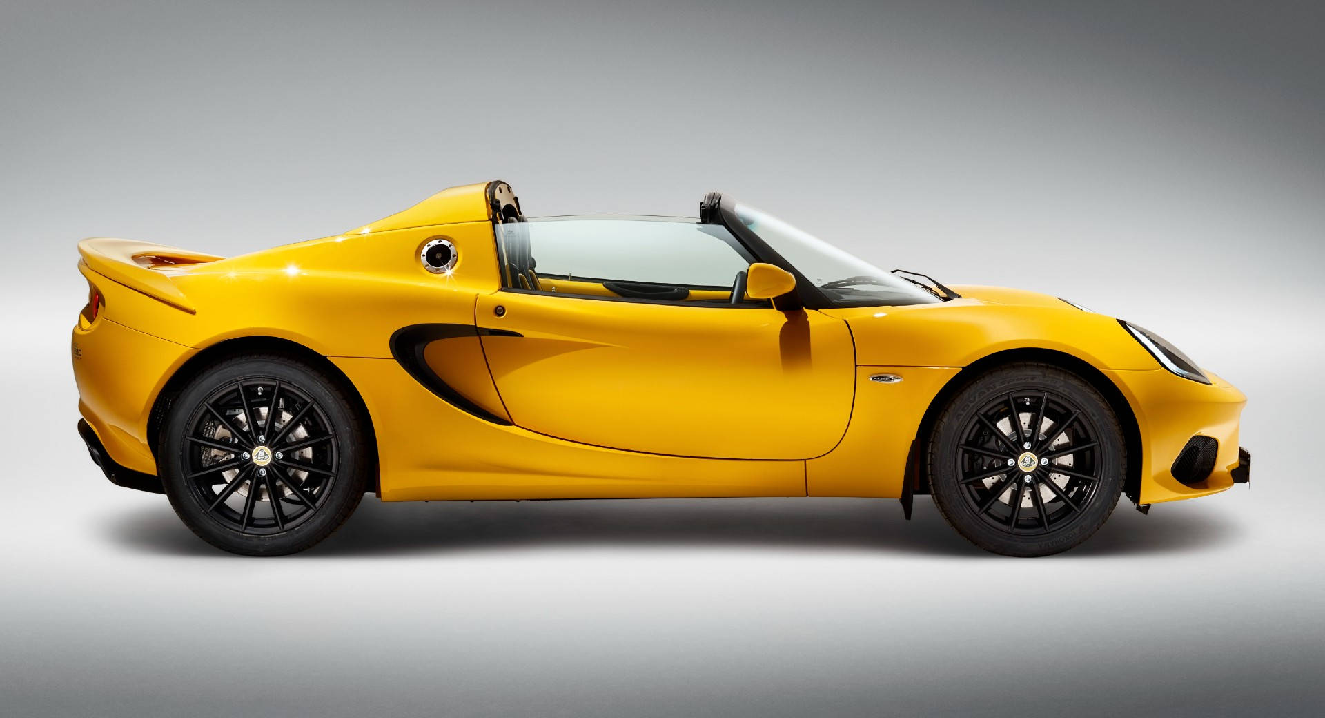 Side perspective of a vibrant Lotus Elise Sports Car. Wallpaper